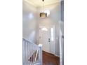 Bright foyer featuring a white door with sidelights, high ceilings, and a modern pendant light at 103 Aurelia St, Palmer Lake, CO 80133