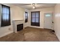 Inviting living room features large windows, a ceiling fan, and a decorative fireplace at 4159 Wyandot St, Denver, CO 80211