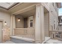 Inviting front porch with classic columns, wood railing, and clear house number display for easy visitor access at 138 Lullaby Ln, Castle Rock, CO 80109