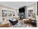 Cozy living room featuring a modern fireplace, large screen tv, and comfortable seating for relaxation at 138 Lullaby Ln, Castle Rock, CO 80109
