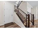 Modern staircase with sleek metal railings and wood steps, leading to upper floors with ample natural light at 138 Lullaby Ln, Castle Rock, CO 80109