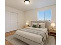 Comfortable bedroom features a neutral color palette, a cozy bed, and a bright window at 5402 Carr St # 307, Arvada, CO 80002