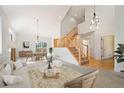 Bright, open-concept living area with vaulted ceilings, modern decor, and staircase to the second level at 7197 Timbers Dr, Evergreen, CO 80439