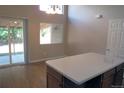 Dining area with wooden floors, a glass sliding door, and a window offering abundant natural light at 2517 S Genoa St, Aurora, CO 80013