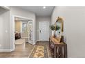 Bright entryway with hardwood floors, decorative rug, and an elegant console table at 3636 Sublime Ct, Castle Rock, CO 80108