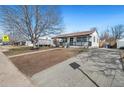 Inviting single-story home with a long driveway and mature trees in the front yard at 1770 S Dahlia St, Denver, CO 80222