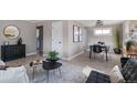 Open-concept living area seamlessly connects with dining space, creating a cohesive and inviting atmosphere at 1770 S Dahlia St, Denver, CO 80222