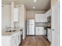 Modern kitchen boasts stainless steel appliances, granite countertops, and ample cabinet space at 48280 Shetland Dr, Bennett, CO 80102