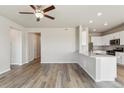 Open-concept living room featuring hardwood floors and recessed lighting at 48280 Shetland Dr, Bennett, CO 80102