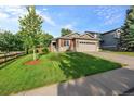 Well-maintained single-Gathering home with a two-car garage and green lawn at 10179 Cherryhurst Ln, Highlands Ranch, CO 80126