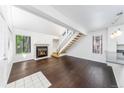 Spacious living room featuring a fireplace, staircase, hardwood floors, and a neutral color palette at 4779 White Rock Cir # B, Boulder, CO 80301