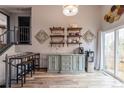 Dining area featuring stylish shelves, a staircase, and lots of natural light from sliding doors at 3943 S Espana St, Aurora, CO 80013