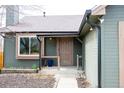 View of a home's front entrance with a covered porch and manicured landscaping at 3943 S Espana St, Aurora, CO 80013