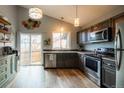 Modern kitchen with stainless steel appliances, stylish cabinets, and lots of natural light at 3943 S Espana St, Aurora, CO 80013