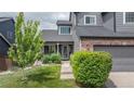 Lovely home with a lush green lawn, mature trees, and well-maintained landscaping at 9758 Red Oakes Dr, Highlands Ranch, CO 80126