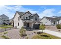Beautifully designed two-story home with a covered front porch and modern color scheme at 1168 Elbridge Dr, Elizabeth, CO 80107