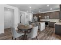 Well-lit kitchen and dining area features stainless steel appliances and a granite island at 1168 Elbridge Dr, Elizabeth, CO 80107