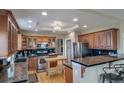 Well-equipped kitchen featuring stainless steel appliances, granite countertops, and wooden cabinets at 40900 Red Fox Cir, Elizabeth, CO 80107