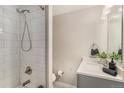 Modern bathroom featuring a subway tiled shower, contemporary vanity with ample storage, and updated fixtures at 4810 W 8Th Ave, Denver, CO 80204
