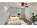 Cozy bedroom with a bright window, ceiling fan, neutral walls, and stylish decor for a relaxing retreat at 4810 W 8Th Ave, Denver, CO 80204