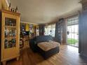 A living room with hardwood floors, bright yellow walls, and unique decorations at 260 Sheridan Blvd, Denver, CO 80226