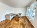 Inviting living room with hardwood floors, neutral-toned seating, and bright natural light at 260 Sheridan Blvd, Denver, CO 80226