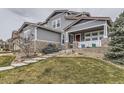 Charming two-story home with a covered porch and manicured lawn at 3880 Fairbrook Pt, Highlands Ranch, CO 80130
