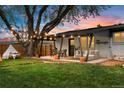 Backyard patio with an outdoor seating area, dining table, string lights, and a hammock at 3103 W Bellewood Dr, Englewood, CO 80110