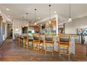 Gourmet kitchen bar featuring stone accents, pendant lighting, and ample seating perfect for entertaining at 142 Outpost Ln, Evergreen, CO 80439