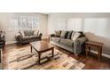 Comfortable living room featuring hardwood floors, neutral color palette, and abundant natural light at 7388 S Lafayette W Cir, Centennial, CO 80122