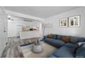 Open concept living room and kitchen, with luxury vinyl floors, stylish decor and updated appliances at 5995 W Hampden Ave # 3I, Denver, CO 80227