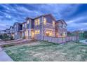 A beautiful townhome featuring a fenced backyard and lush green lawn at 24806 E Calhoun Pl # A, Aurora, CO 80016