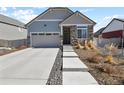 Charming home with a two-car garage, stone accents, and a well-maintained front yard at 4478 Riviera Ct, Aurora, CO 80019