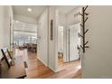Inviting entryway with wood floors, leading to an open-concept living area and bathroom at 4478 Riviera Ct, Aurora, CO 80019