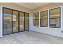 Covered patio area featuring sliding glass doors and multiple windows for natural light at 11453 Autumn Moon St, Littleton, CO 80125