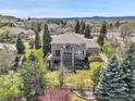 Expansive backyard featuring a multi-tiered deck and lush landscaping, perfect for outdoor living at 3266 Coyote Hills Way, Castle Rock, CO 80109