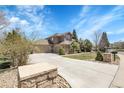 Stunning two-story home with a three-car garage and beautifully manicured front yard at 3266 Coyote Hills Way, Castle Rock, CO 80109