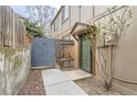 Cozy side entrance with a small porch roof, privacy fence, and mature tree at 7700 W Glasgow Pl # 6C, Littleton, CO 80128