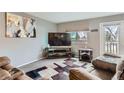 Comfortable living room with a large window, TV, and plush seating at 7700 W Glasgow Pl # 6C, Littleton, CO 80128