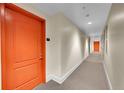 Hallway with neutral walls, carpet, and bright orange doors to the residential units at 300 W 11Th Ave # 8C, Denver, CO 80204