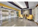 Modern lobby with sleek gray floors, unique ceilings and a cozy sitting area near the elevators at 300 W 11Th Ave # 8C, Denver, CO 80204