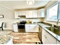 Bright kitchen featuring white cabinets, stainless steel appliances, and granite countertops at 7901 Newport St, Commerce City, CO 80022