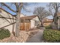 This townhome features a privacy fence, neutral siding, stone accents, and a walkway on a well-maintained lot at 16036 E Ithaca Pl # E, Aurora, CO 80013