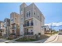 Modern three-story home featuring a stone facade and a small front yard at 11400 W Grand Ave, Littleton, CO 80127