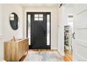 Welcoming entryway with hardwood floors, a stylish mirror, and modern decor at 3322 N Columbine St, Denver, CO 80205