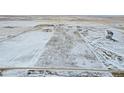 Aerial view of a large, open field with light snow cover at 43620 E 80Th Ave, Bennett, CO 80102