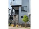 Stylish townhome with a private balcony, stone accents, and contemporary design at 2066 S Holly St # 3, Denver, CO 80222