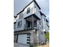 Modern townhome exterior featuring light blue siding, stone accents, and a private balcony at 2066 S Holly St # 3, Denver, CO 80222