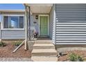 Inviting front entrance showcases a green door and manicured plants at 3975 S Logan St, Englewood, CO 80113