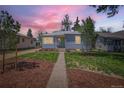 Inviting single-story home featuring beautiful landscaping and a walkway leading to the front door at 3975 S Logan St, Englewood, CO 80113